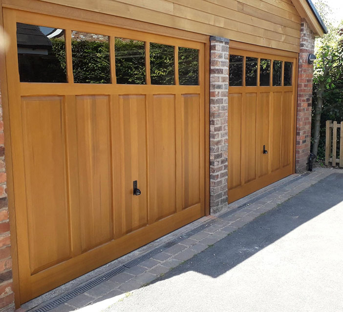 Woodrite cedar Padbury up and over garage doors with plain glazing